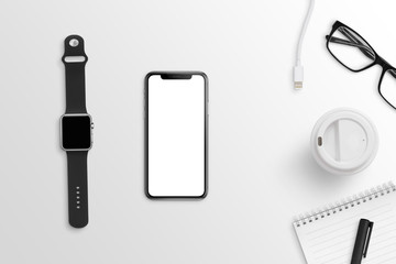 Fototapeta na wymiar Smart mobile phone and watch on clean office desk. Black and white composition. Flat lay.
