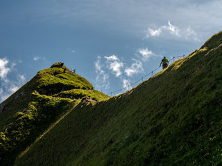 people walking scary ridge walk during sunny summer day swiss alps hohenweg