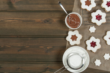 Homebaked Christmas Star Cookies With Chocolate, Cherry Jam, Icing Sugar.