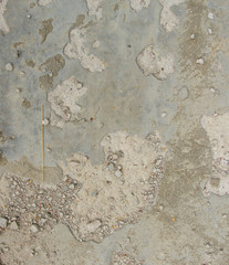 old cracked cement floor with sand and potholes