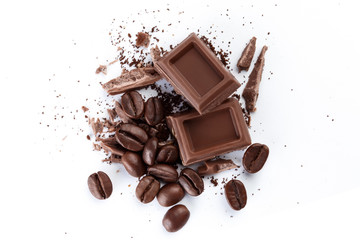 Chocolate pieces and roasted coffee beans, isolated on white background, view from above