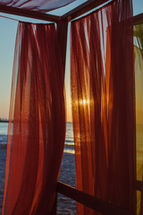 Looking from inside tent toward view of the beach at sunrise.