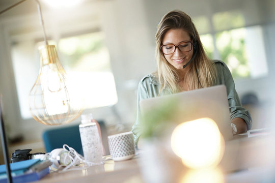 Business Girl In Home-office Using Headset