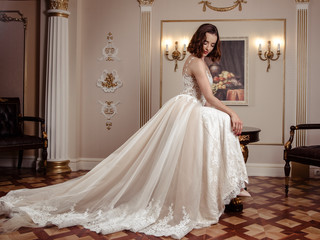 Fototapeta premium Sensual brunette bride in luxury wedding dress over classic interior, fashion beauty portrait