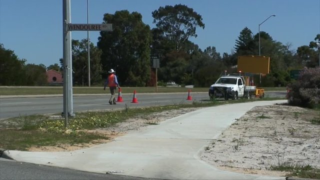 Road Workers In Hi Vi Road Roadside Managing The Traffic Flow Of Cars And Trucks Safely Around Workmen. Traffic Management. Traffic Control In Perth Australia.