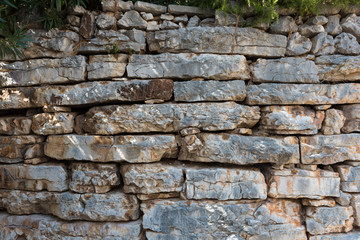 Old stone wall surface as background, wallpaper.