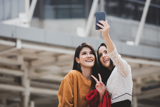 woman and friend taking selfie