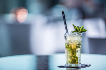 Mojito summer alcoholic cocktail on table in restaurant