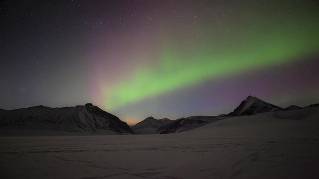 Camping under the aurora borealis in alaska, (northern lights.) Winter, snow.
