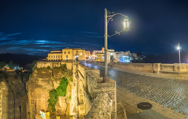 Puente Nuevo bridge and the houses built on the edge of the cliff at night, in the ancient city of Ronda, Spain. © elroce