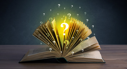 Yellow question marks hovering over open book 