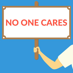 NO ONE CARES. Hand holding wooden sign