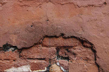 Red broken old brick wall