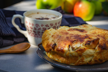 Homemade apple pie with cup of coffee outdoor, country style.