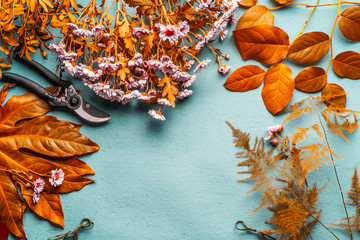 Autumn flowers decoration and flowers arrangement background with yellow leaves and pink flowers on...