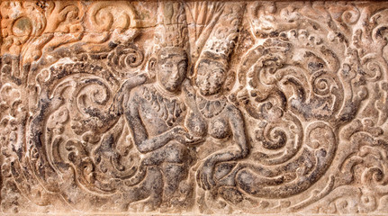 Example of indian artworks from near 7th century, man touching chest of the young woman on a bas-relief inside Hindu temple in Karnataka, India