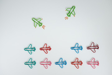 Group of plan paperclip with another two green plane paperclip is point to another direction for...