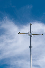 Fototapeta na wymiar metal cross on the blue sky background