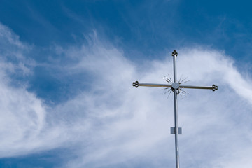 metal cross on the blue sky background
