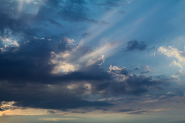 Clouds with sun beams on a summer day