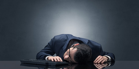 Young businessman fell asleep at his workplace with copy space