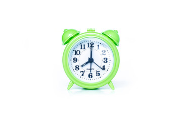 green alarm clock on white background
