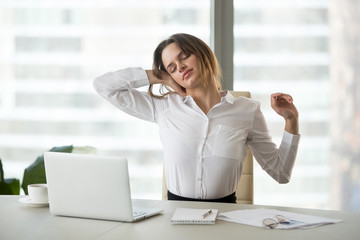 Exercise for neck muscles in office. Female business worker massage neck, stretching in chair,...