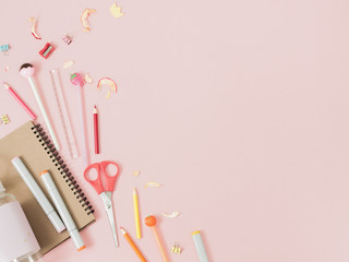 Colorful stationery on pastel pink background, school concept