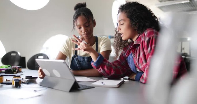 High school students working on robotics in class