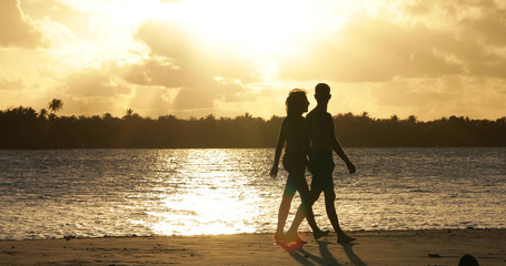  a couple on the beach with sunset