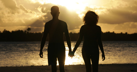 a couple on the beach with sunset