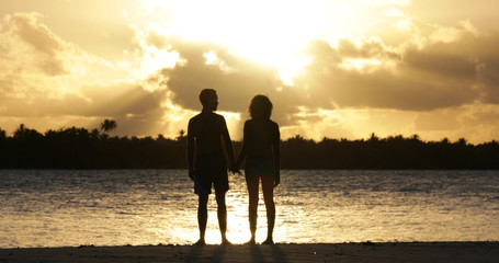 Fototapeta premium a couple on the beach with sunset