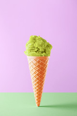Ice cream cone isolated on a colorful background. Copy space. Vivid colors