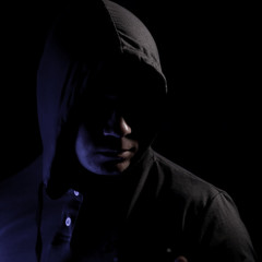 The man's portrait in a hood in the dark.