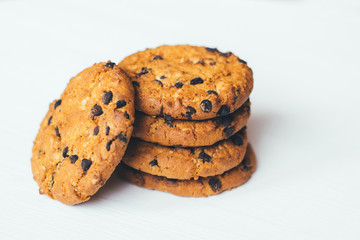 Chocolate cookies stacked on a white background