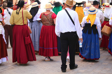 Fototapeta na wymiar Locals in traditional Canarian dresses at a public festival in San Sebastian de la Gomera