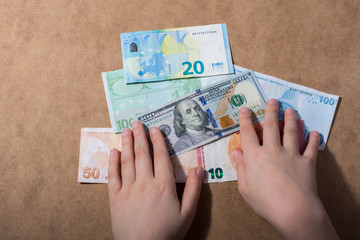 Hand holding American dollar  isolated on wooden background