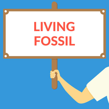 LIVING FOSSIL. Hand holding wooden sign