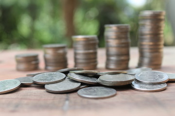 Stack of money coins arranged as a graph on wooden table