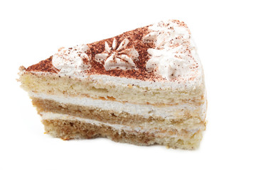 Piece of a white cake with flowers and chocolate chips isolated on a white background