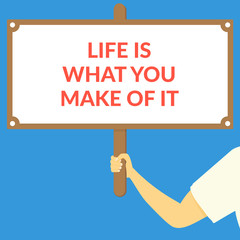 LIFE IS WHAT YOU MAKE OF IT. Hand holding wooden sign