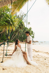 Happy young married couple celebrating their wedding on the beach
