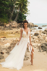 Fototapeta na wymiar Bride wearing beautiful wedding dress on the tropical beach