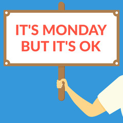 IT'S MONDAY BUT IT'S OK. Hand holding wooden sign