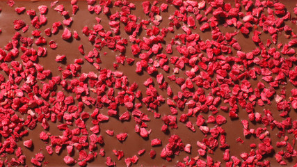 texture of milk chocolate with raspberry; macro; 4k background 16:9