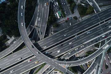 Aerial view of highway and overpass in city on sunny day - obrazy, fototapety, plakaty