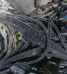 Aerial view of highway and overpass in city on sunny day