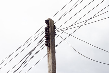 The electrical wires on the power poles under the sky.