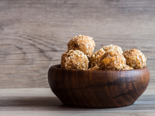 Wooden bowl full of homemade walnut balls, traditional Christmas sweets