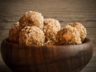 Wooden bowl full of homemade walnut balls, traditional Christmas sweets